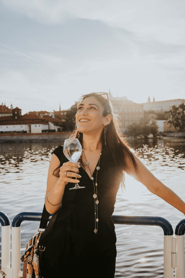 Aylet Halamish standing by water holding a glass