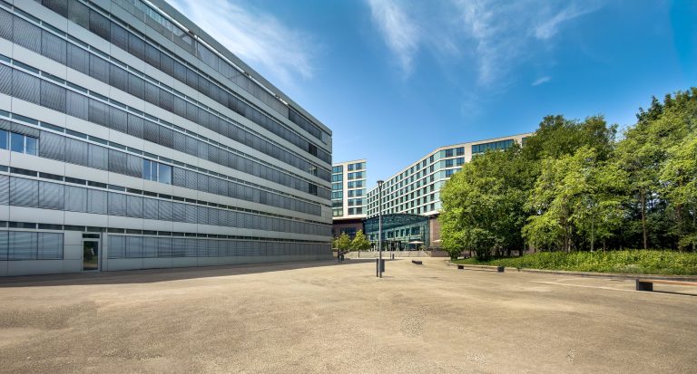 Modern office buildings and greenery, a stock business setting