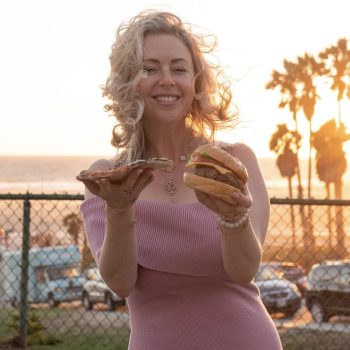 alina z holding a cheeseburger