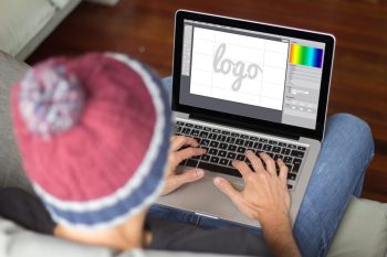 Young man on the sofa designing a logo